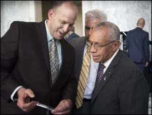 Mike Adelstein shows NASA Administrator Charles Bolden micro parts fabricated at Potomac. 